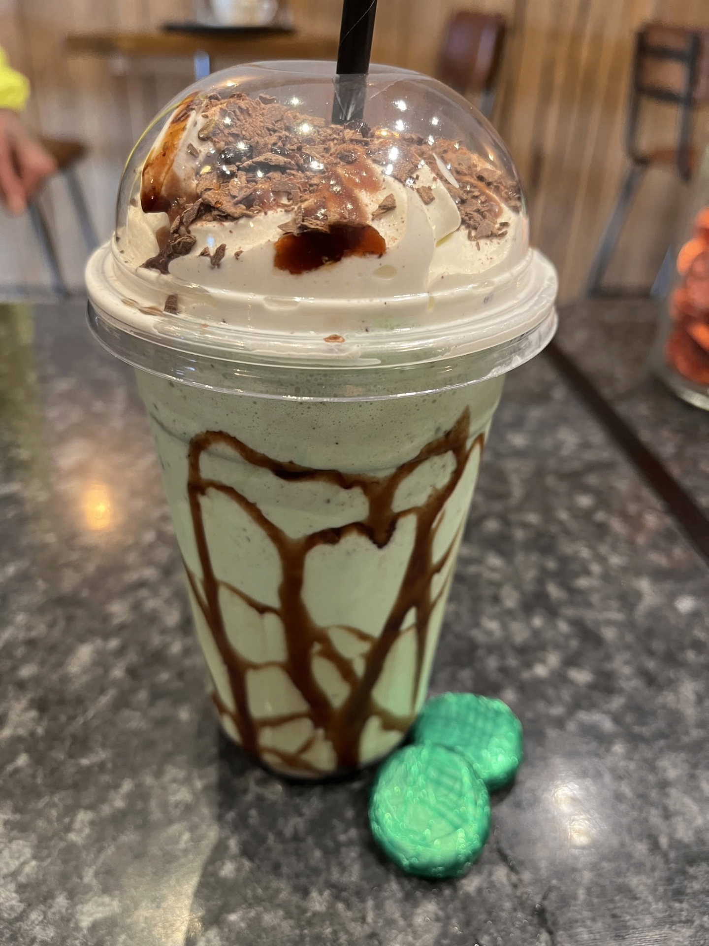 Mint chocolate milkshake topped with whipped cream and chocolate